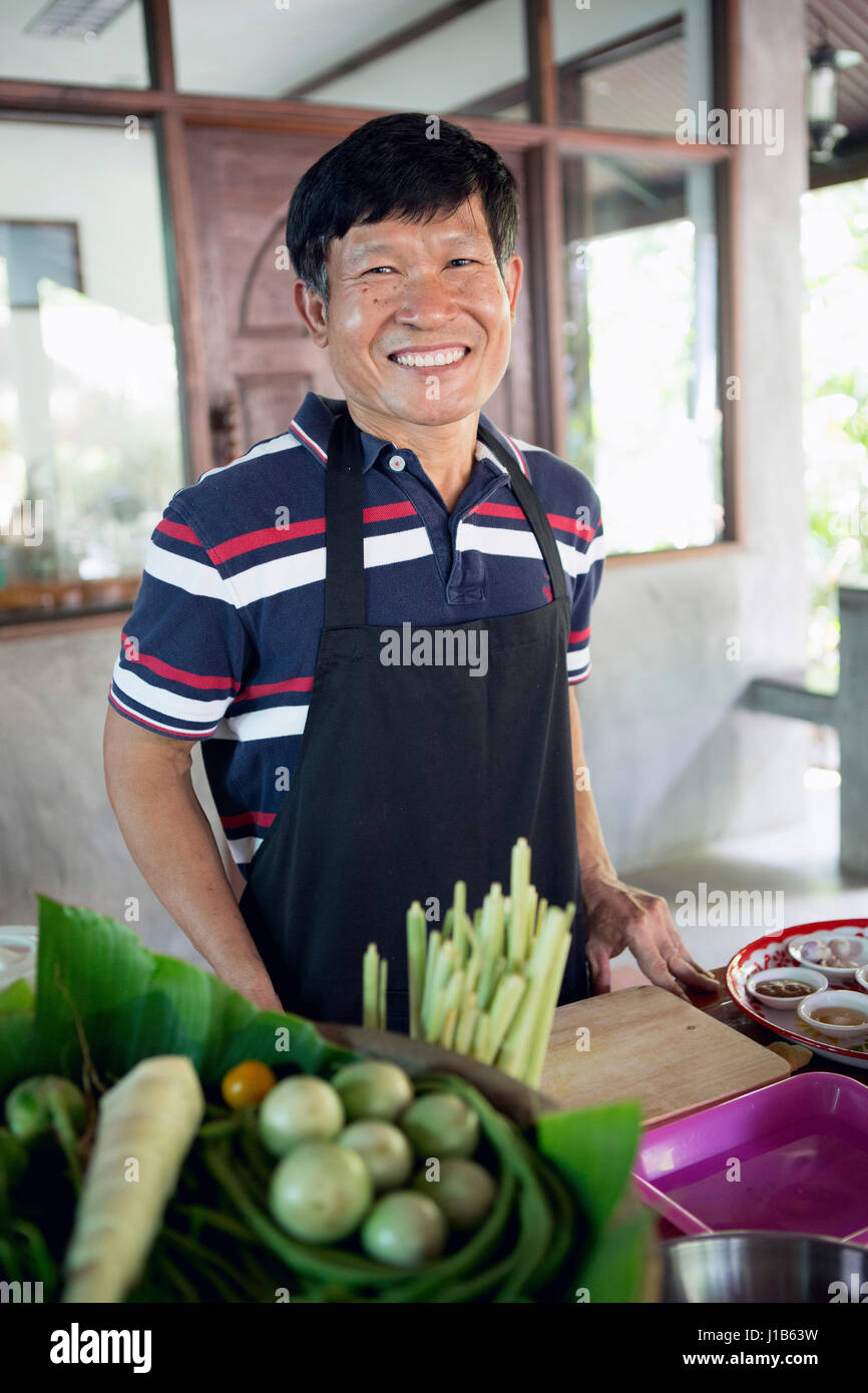 Smiling Thai man preparing food Stock Photo