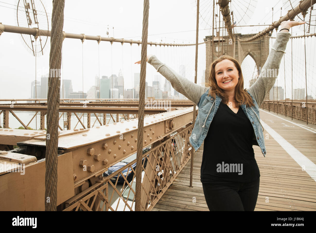 Portrait of smiling Caucasian woman on bridge Stock Photo
