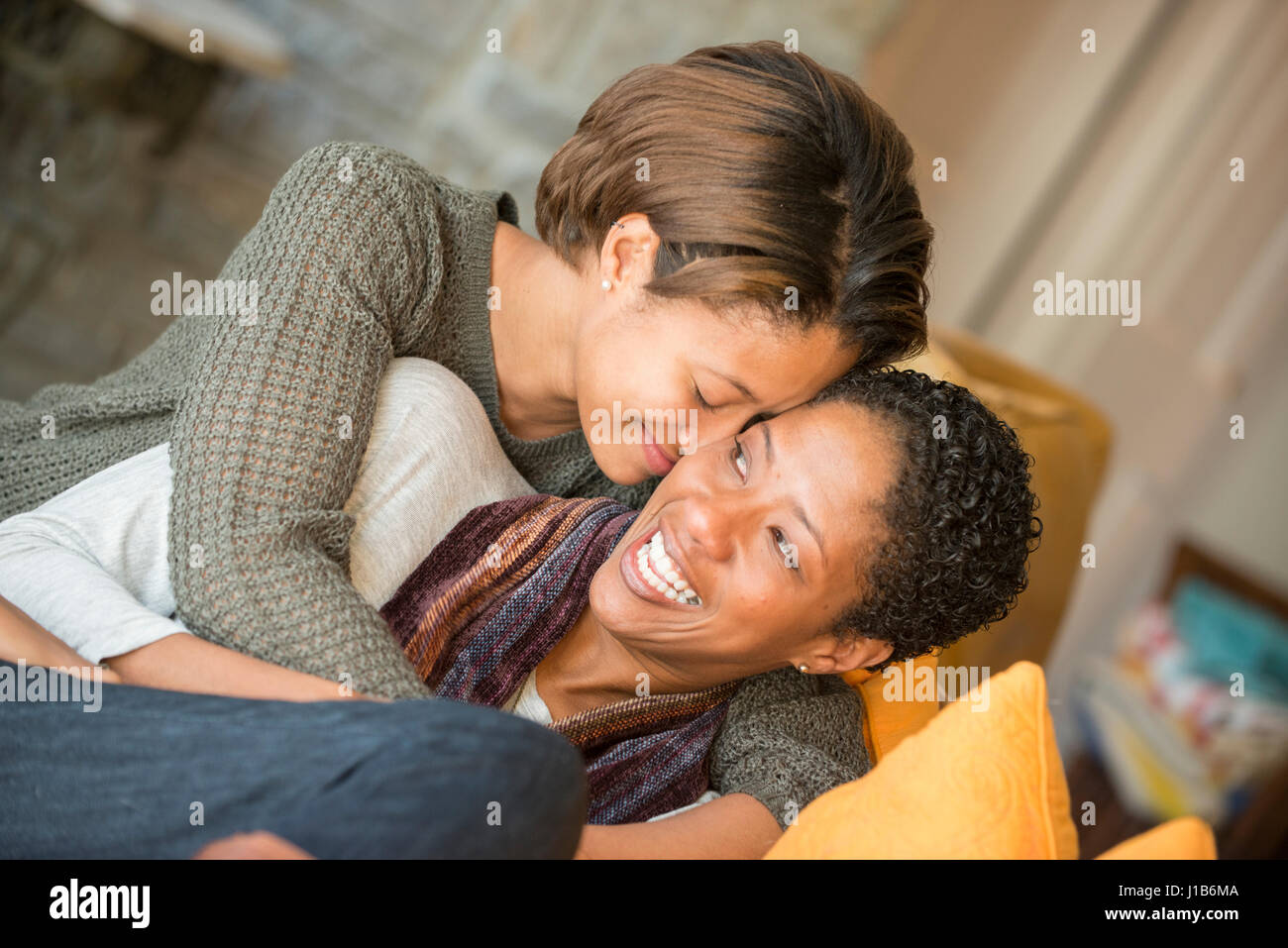 Mixed Race mother and daughter hugging Stock Photo