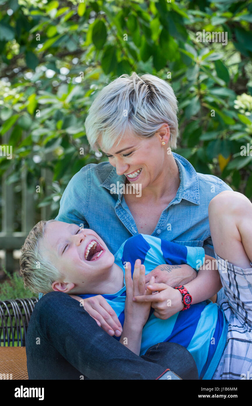 Caucasian woman tickling son outdoors Stock Photo
