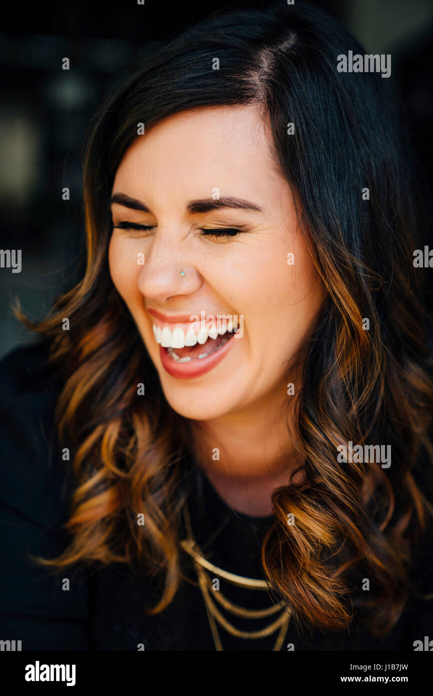 Portrait of laughing Mixed Race woman with pierced nose Stock Photo