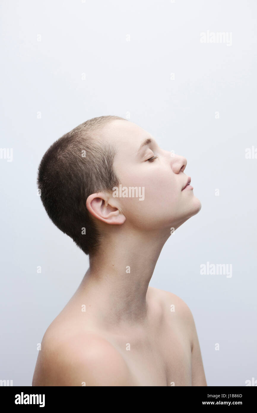 Profile of Caucasian woman with shaved-head Stock Photo