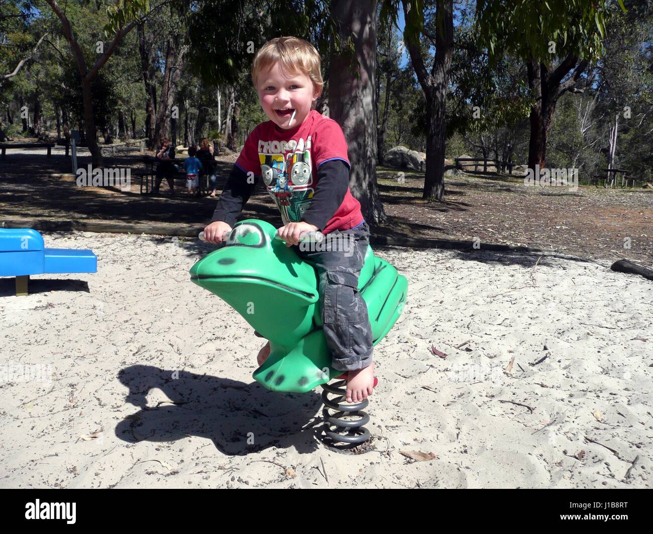 Young boy playing in a playground Stock Photo - Alamy
