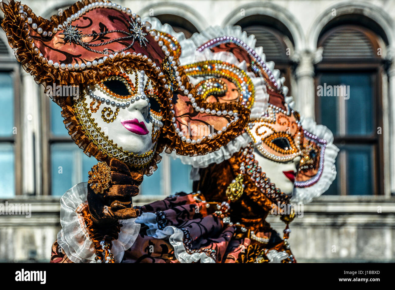 Beautiful young woman in mysterious colors Venetian mask. Fashion photo.  Holidays and celebrations Stock Photo - Alamy