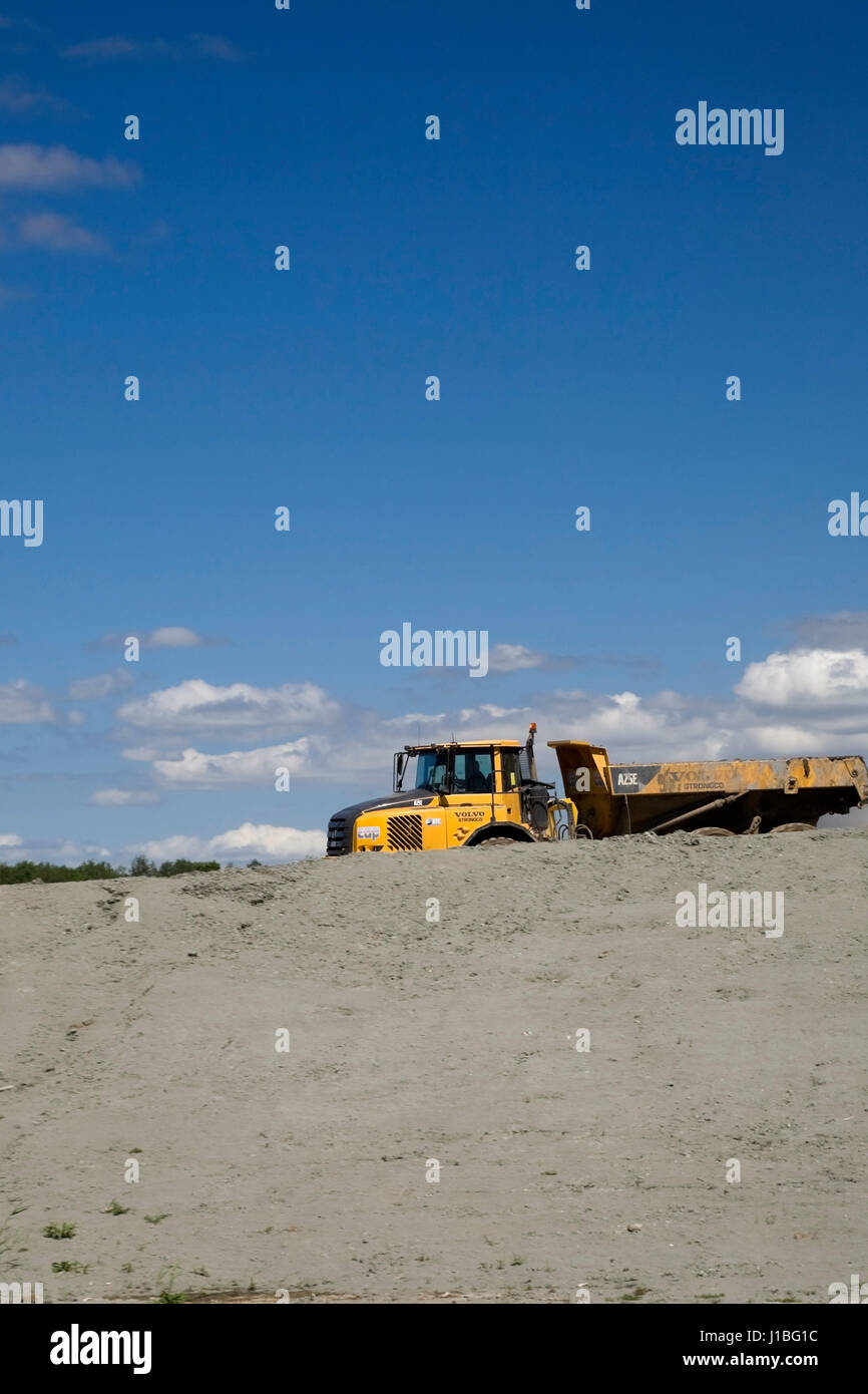 Volvo loader on a hilltop at a waste management site. Stock Photo