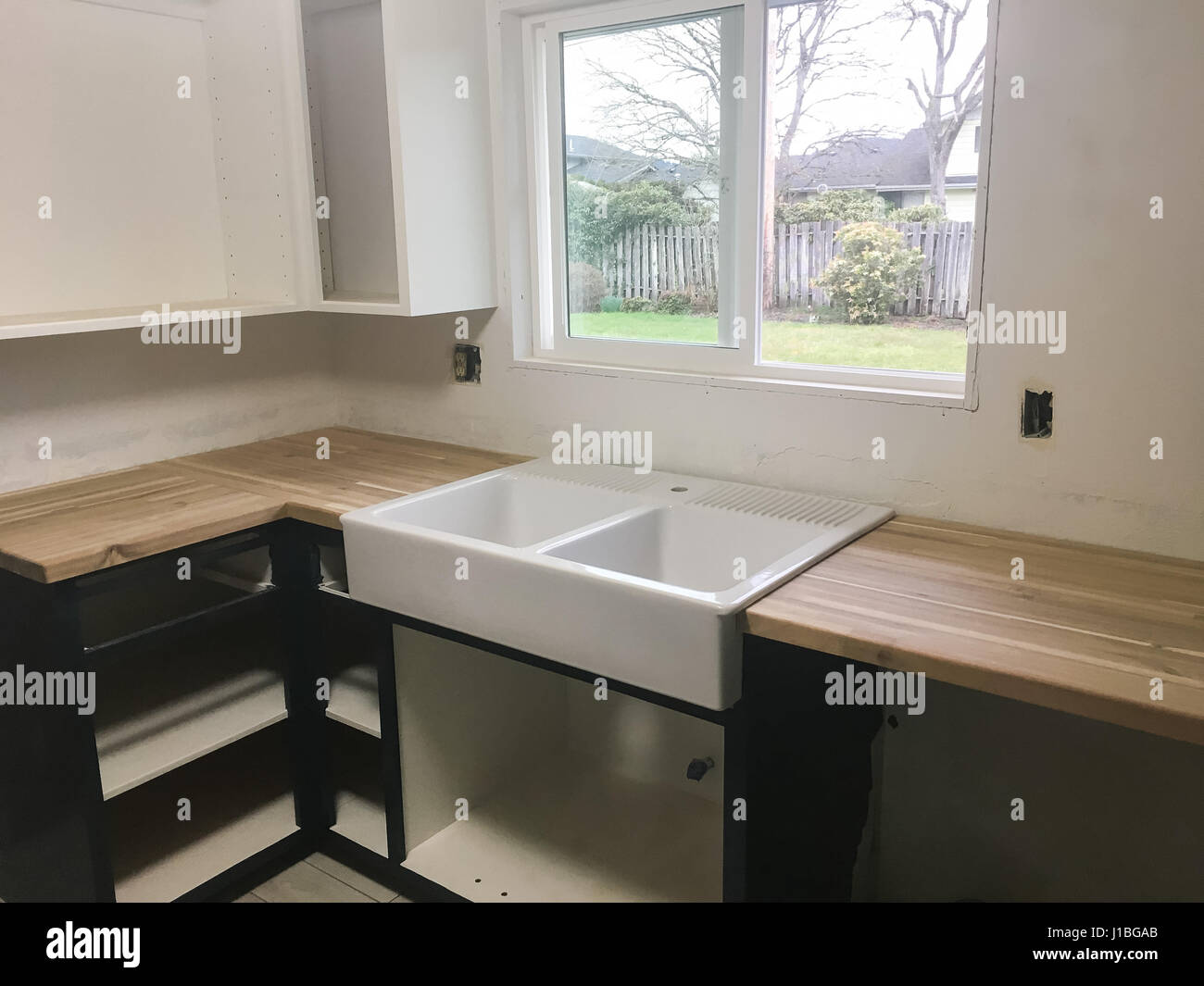 Large farmhouse sink in the kitchen of a full renovation and house remodel. Stock Photo