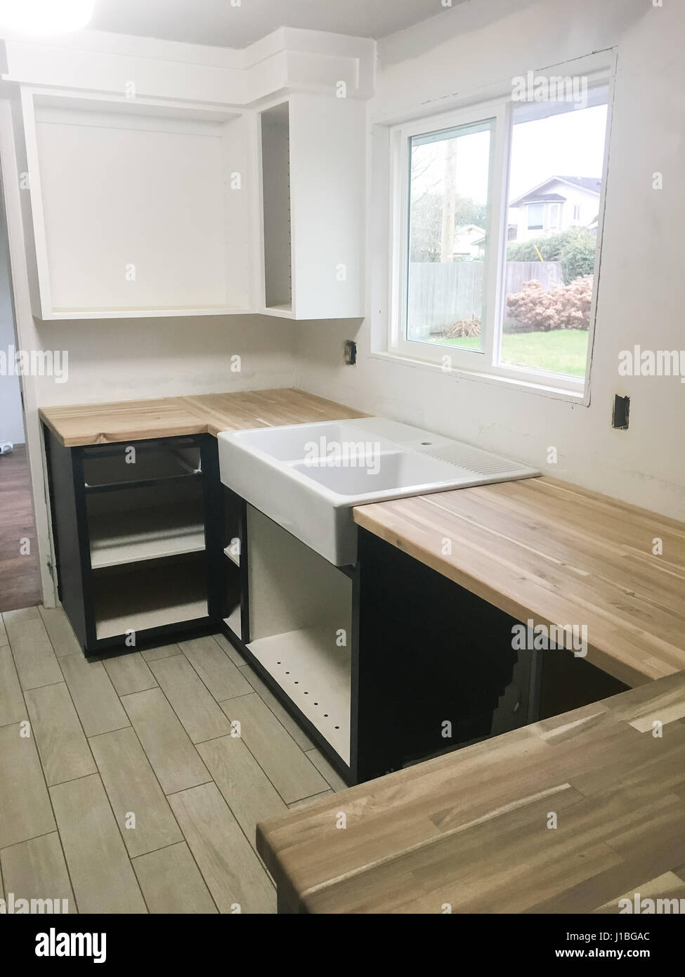 Large farmhouse sink in the kitchen of a full renovation and house remodel. Stock Photo