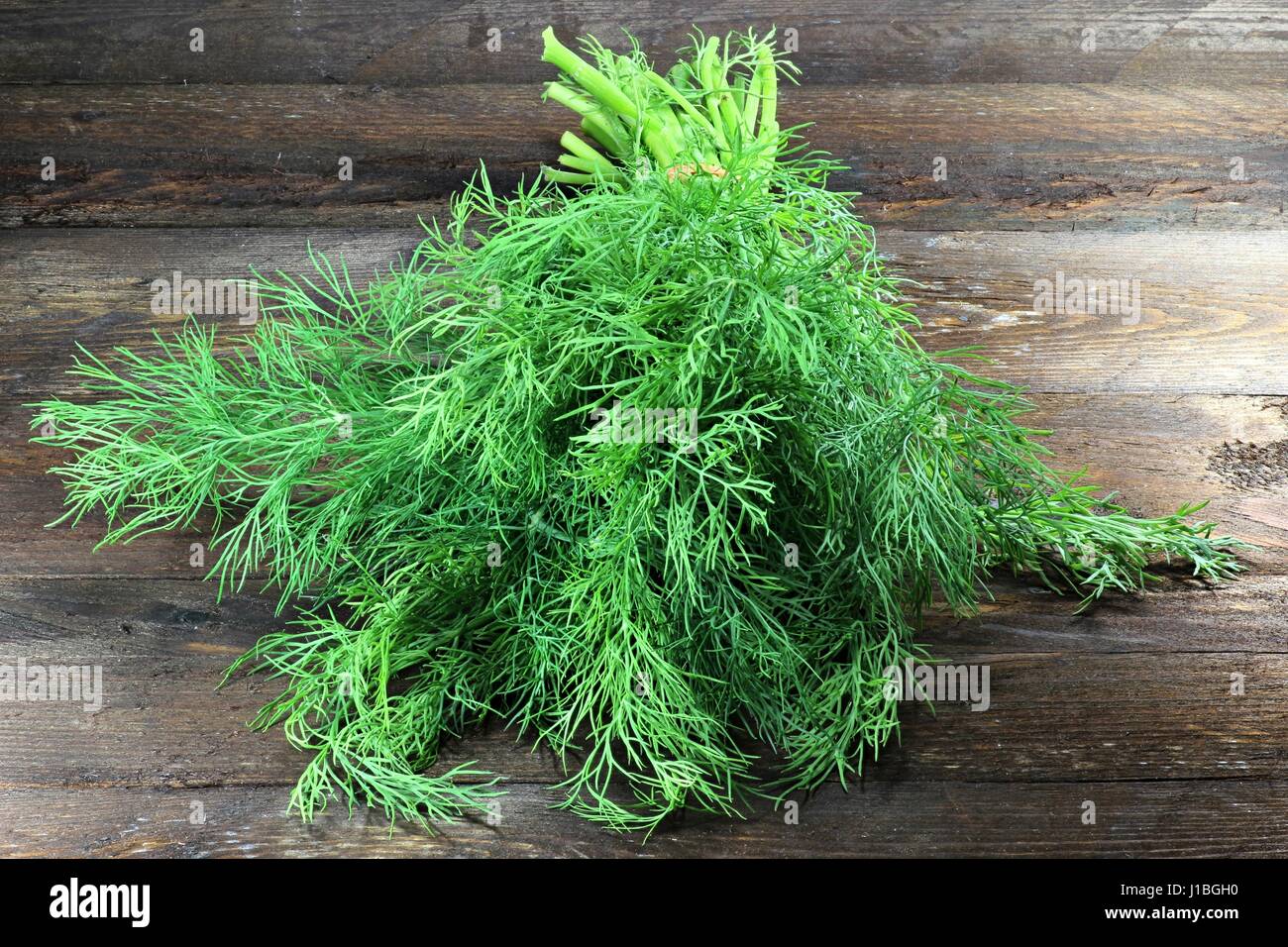 bunch of dill on wooden background Stock Photo
