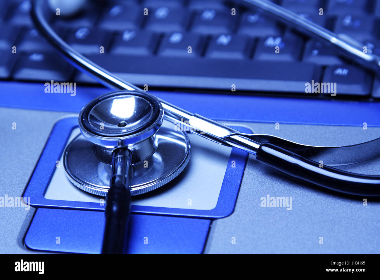 A stethoscope and a laptop in a blue tone Stock Photo - Alamy