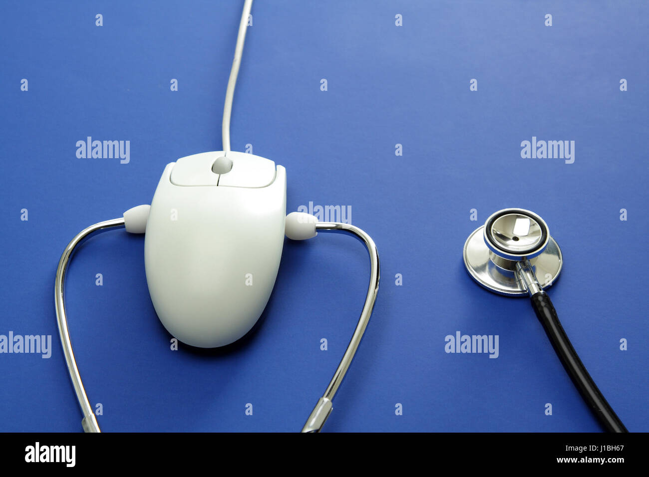 A stethoscope and a mouse in a blue background Stock Photo Alamy