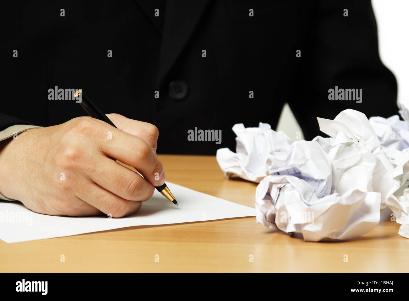 A businessman writing on a piece of paper Stock Photo - Alamy
