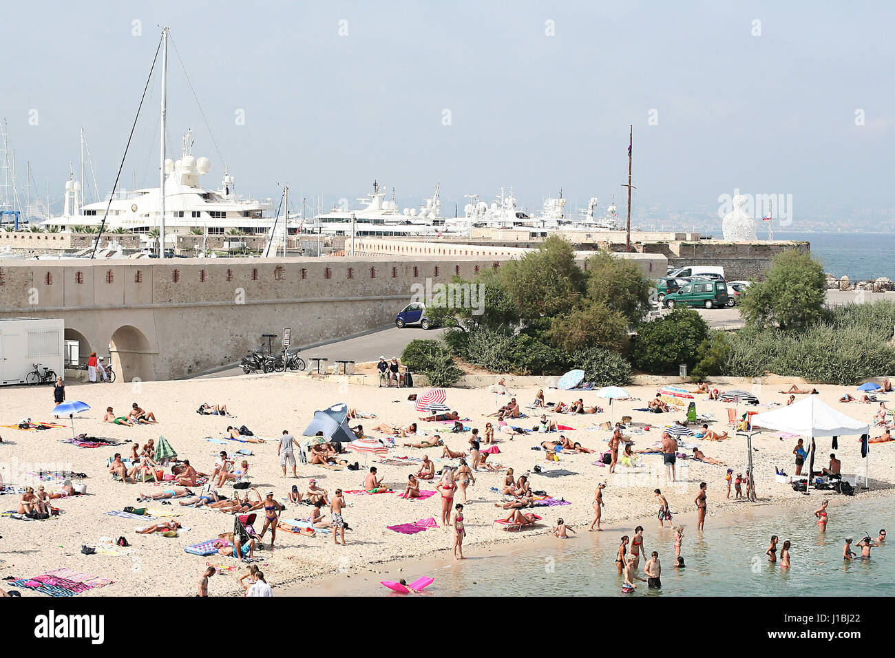 Busy crowded small private beach in Cannes, France Stock Photo