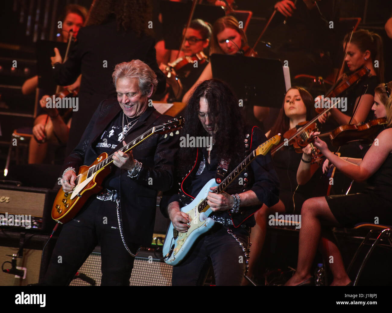 Wetzlar, Germany, 13th April, 2017. Don Felder (left), ex-guitarist of Californian country rock band Eagles (here with guitarist Alex Beyrodt/Mat Sinner Band, right) performs at Rock meets Classic 2017, concert show with rock legends as soloists, accompanied by Mat Sinner Band and Bohemian Symphony Orchestra Prague. Venue: Rittal-Arena, Wetzlar, Germany. Fotocredit: Christian Lademann Stock Photo