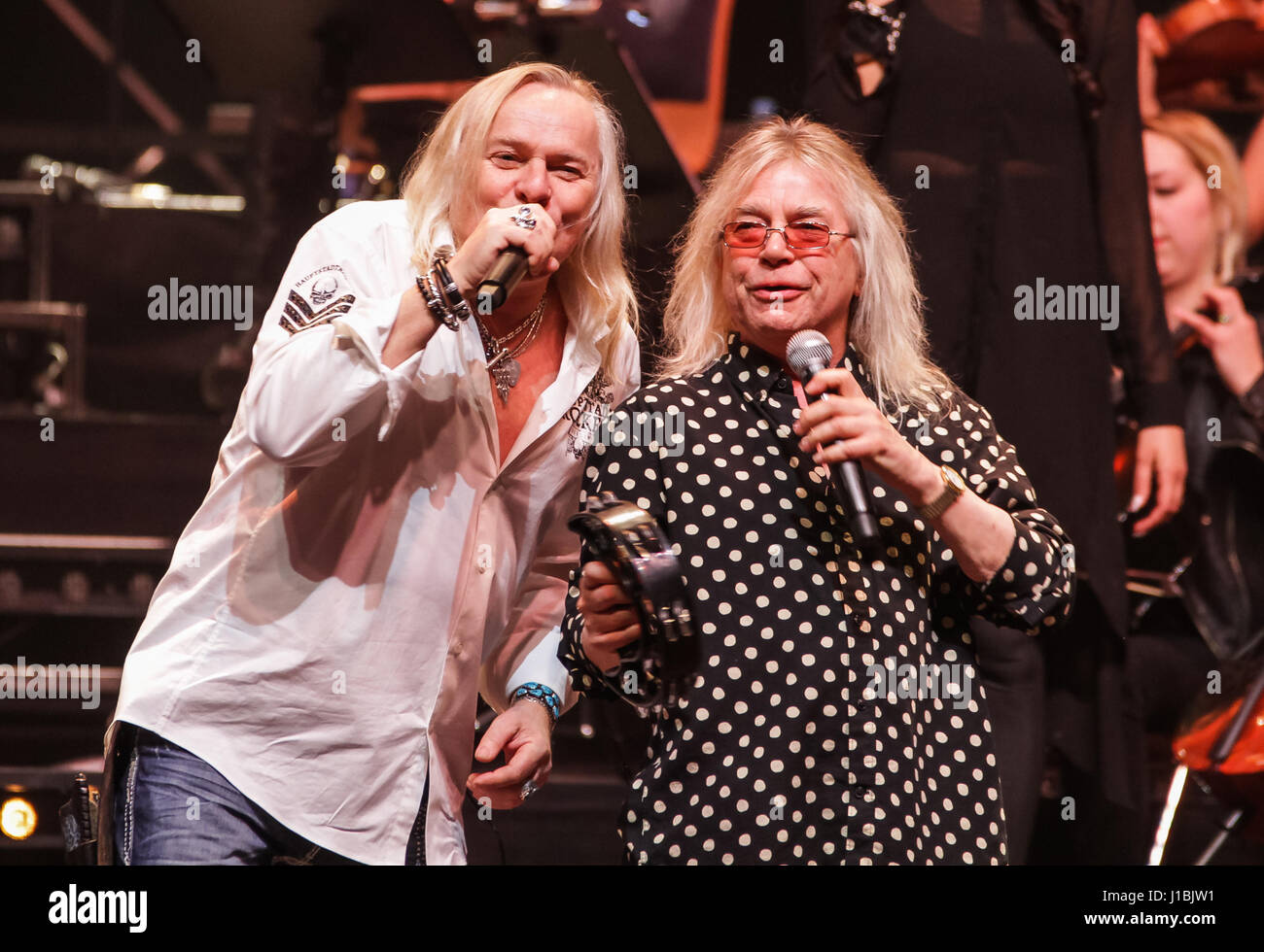 Wetzlar, Germany, 13th April, 2017. Bernie Shaw, singer of british hard rock band Uriah Heep, and Bob Catley, singer of british hard rock band Magnum, perform at Rock meets Classic 2017, concert show with rock legends as soloists, accompanied by Mat Sinner Band and Bohemian Symphony Orchestra Prague. Venue: Rittal-Arena, Wetzlar, Germany. Fotocredit: Christian Lademann Stock Photo