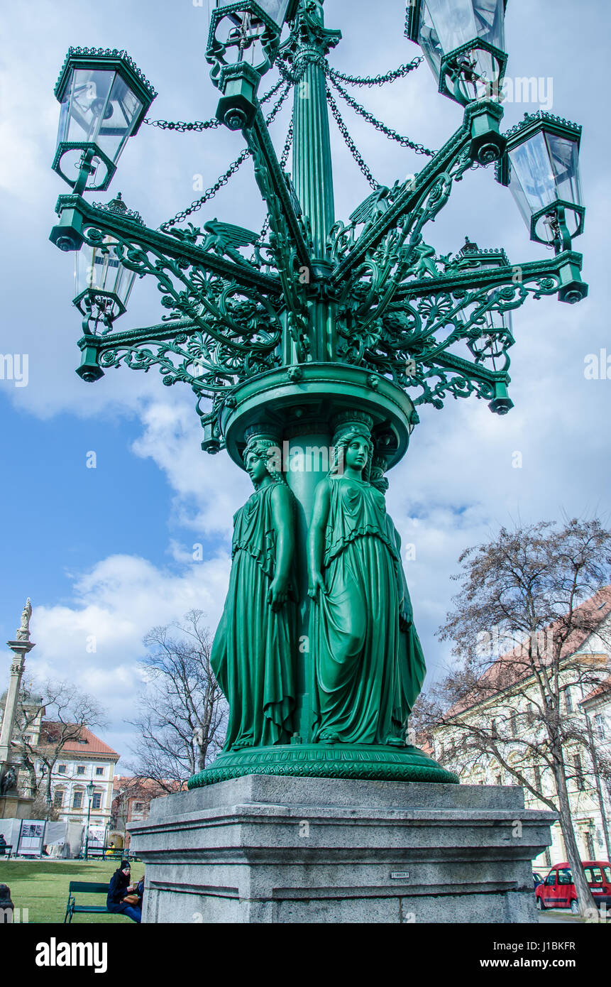The cast-iron lamppost forged in year 1868 with its female figures on Hradcany Square near Prague Castle  is one of three left. Stock Photo