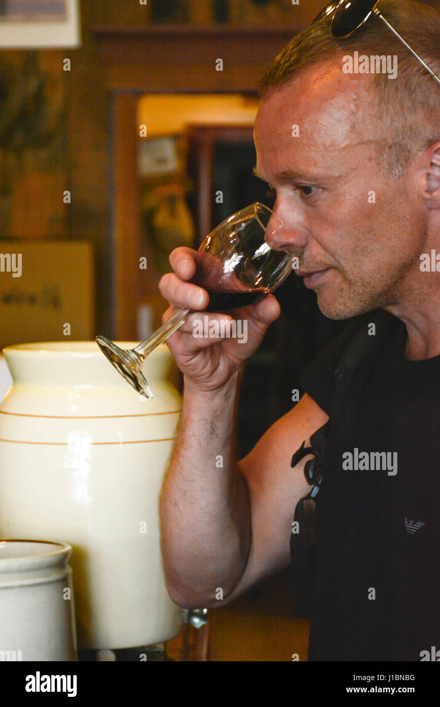 Men enjoy a wine tasting session inside the Los Olivos Tasting Room & Wine Shop in Los Olivos, CA Stock Photo