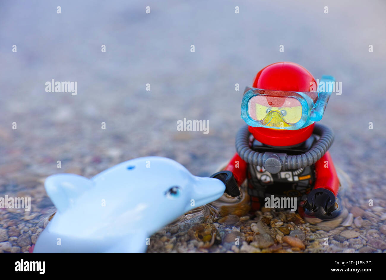 Paphos, Cyprus - October 09, 2016 Lego scuba diver and dolphin in the sea. Shallow depth of field. Stock Photo