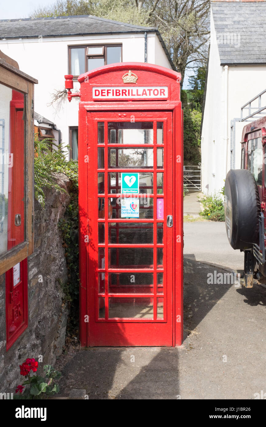 Old red telephone box converted to store a defibrillator Stock Photo