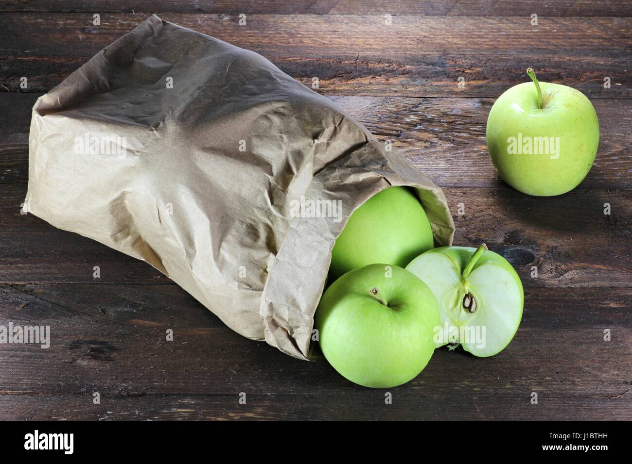 apples (variety Delcorf) in a paper bag on wooden background Stock Photo