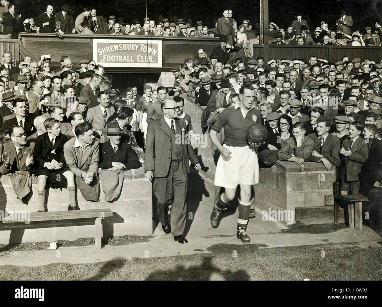 Shrewsbury Town football club captain Roly Depear leading the team out at the Gay Meadow. August 1950 Stock Photo