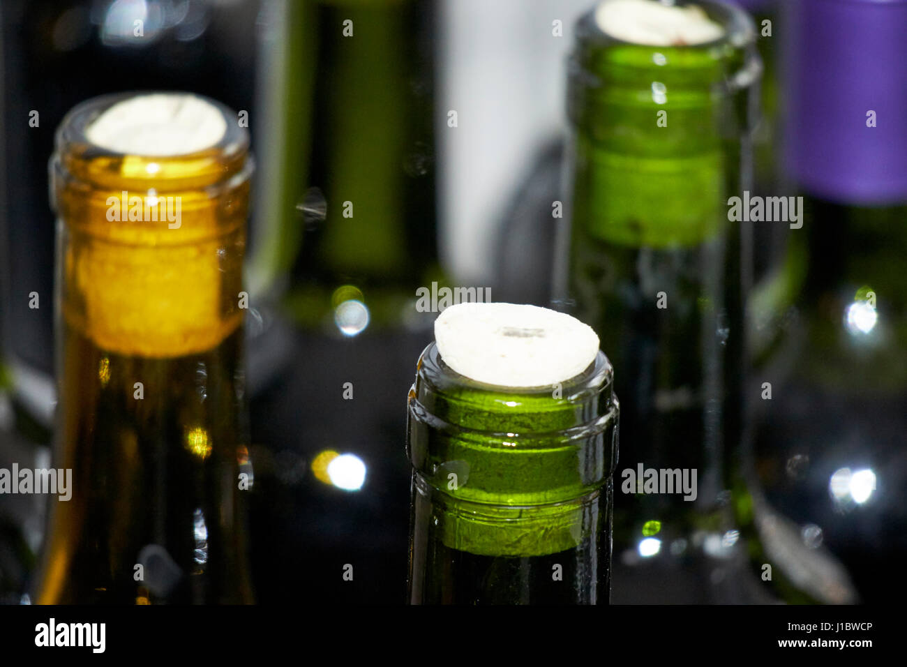 used wine bottles with corks filled with home made wine for home wine production Stock Photo