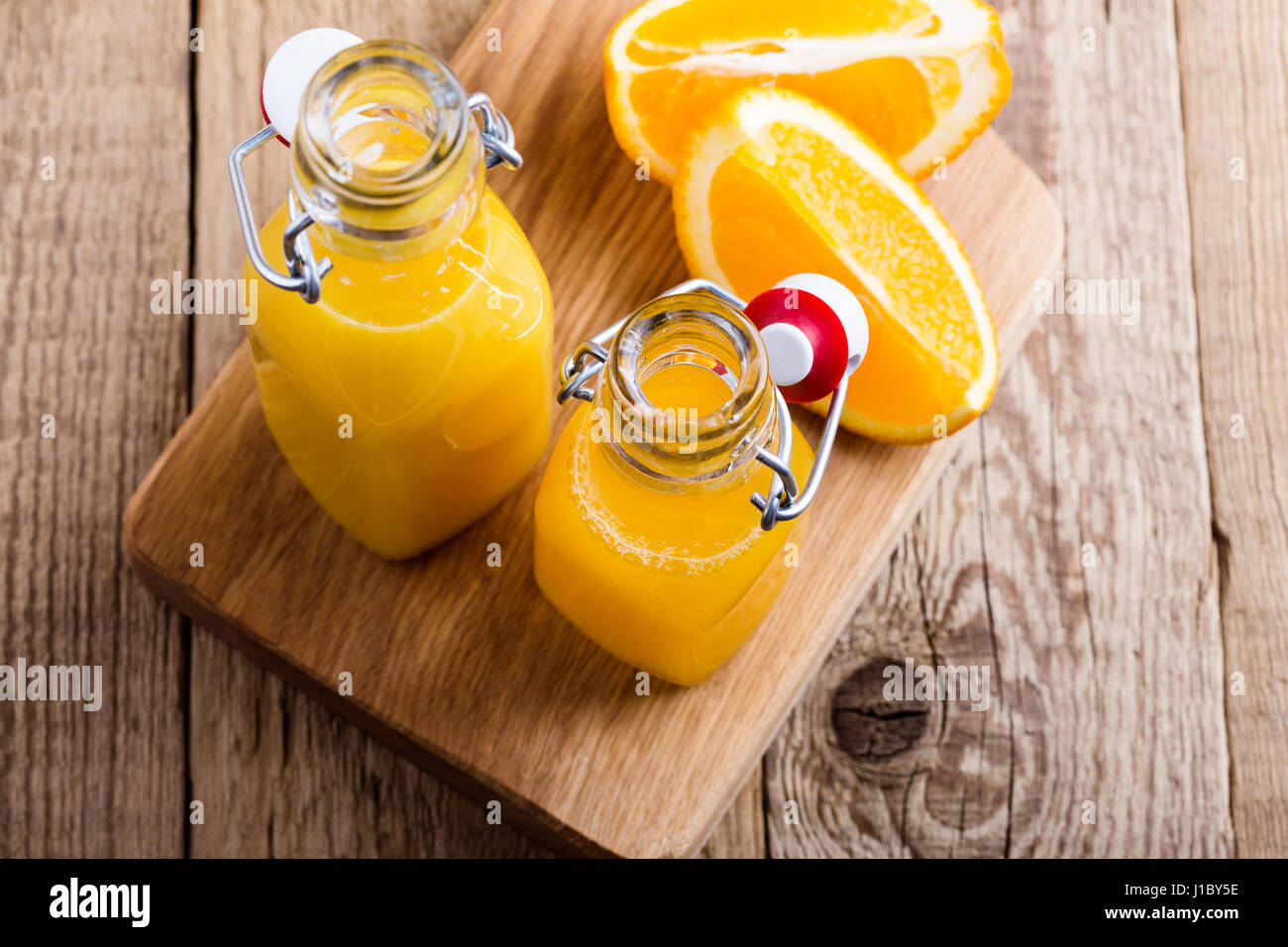 Freshly squeezed orange juice in bottles against the background of
