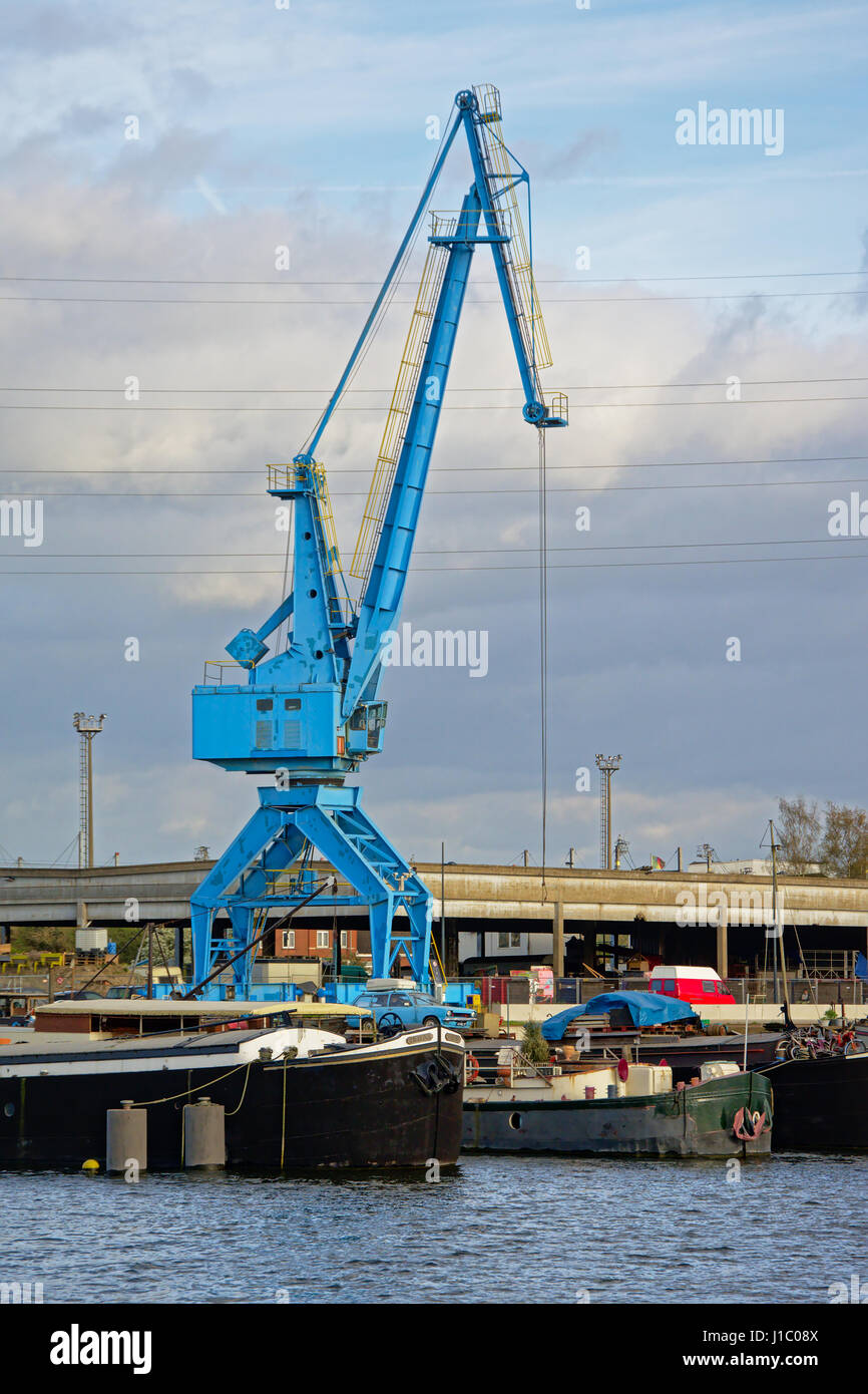 Blue crane with living boats in front in `Dok Noord` harbor along river  Scheltd in Ghent, Flanders Stock Photo - Alamy