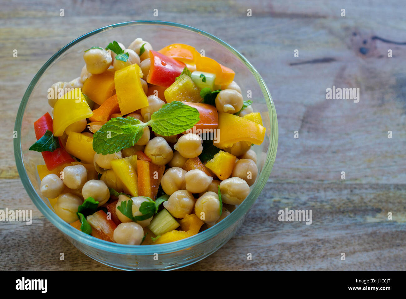 Garbanzo bean salad in transparent glass bowl healthy eating concept