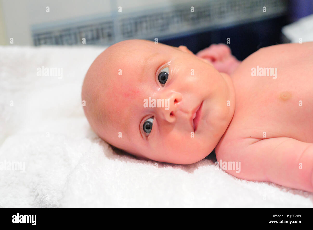 Mom puts a diaper on the baby Stock Photo