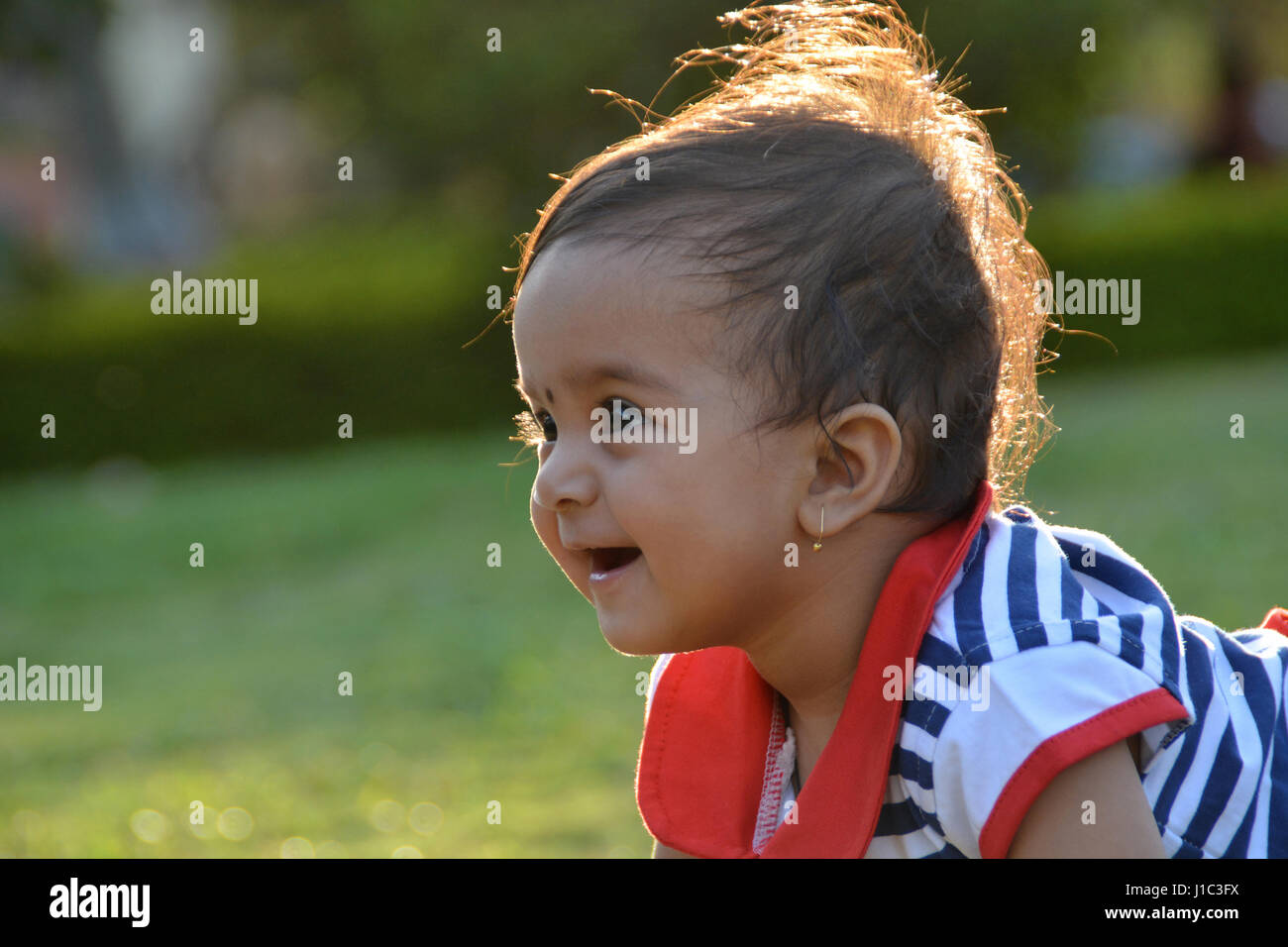 Baby girl playing in the garden, Pune, Maharashtra. Stock Photo