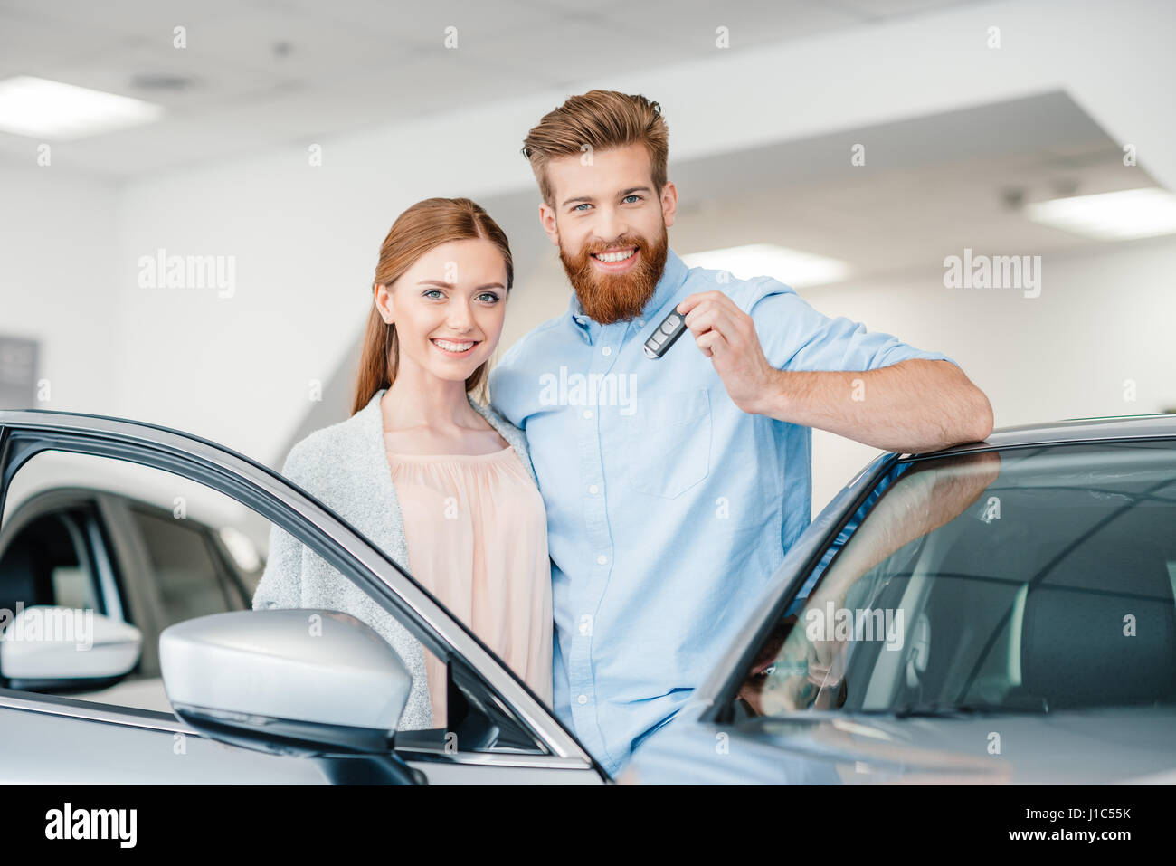 Key Car Dealership >> Happy Couple Holding Car Key And Standing At Car In Key Car Dealership >> Happy Couple Holding Car Key And Standing At Car In
