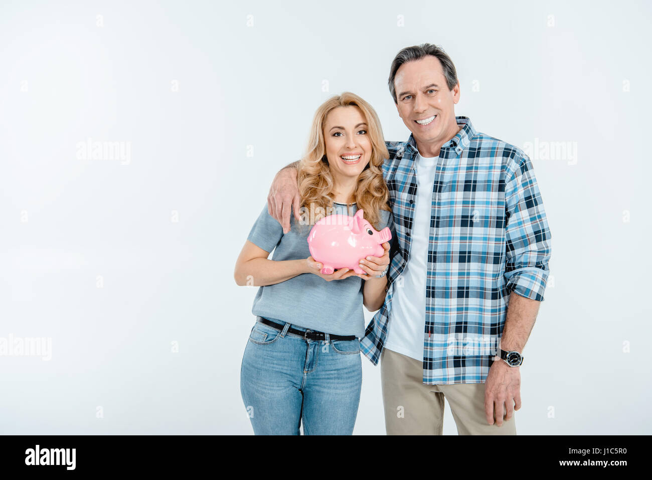 Couple with piggy bank hi-res stock photography and images - Alamy