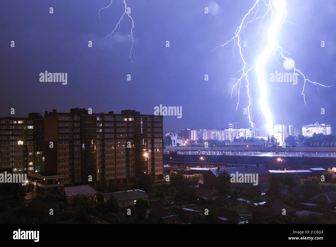 Lightning striking city at night Stock Photo
