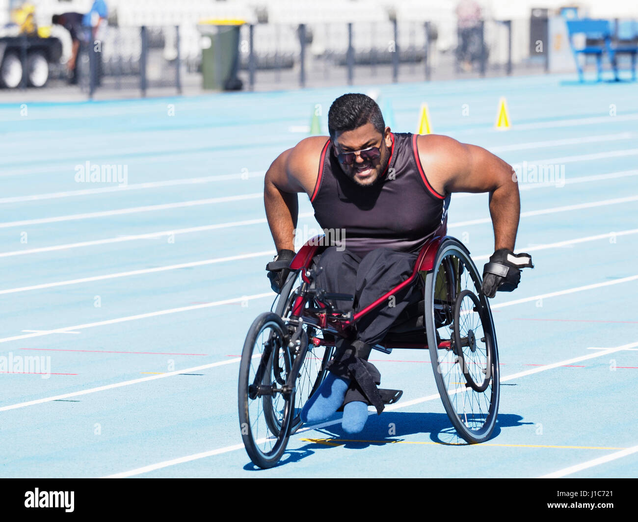 Middle Eastern man racing in wheelchair on track Stock Photo - Alamy