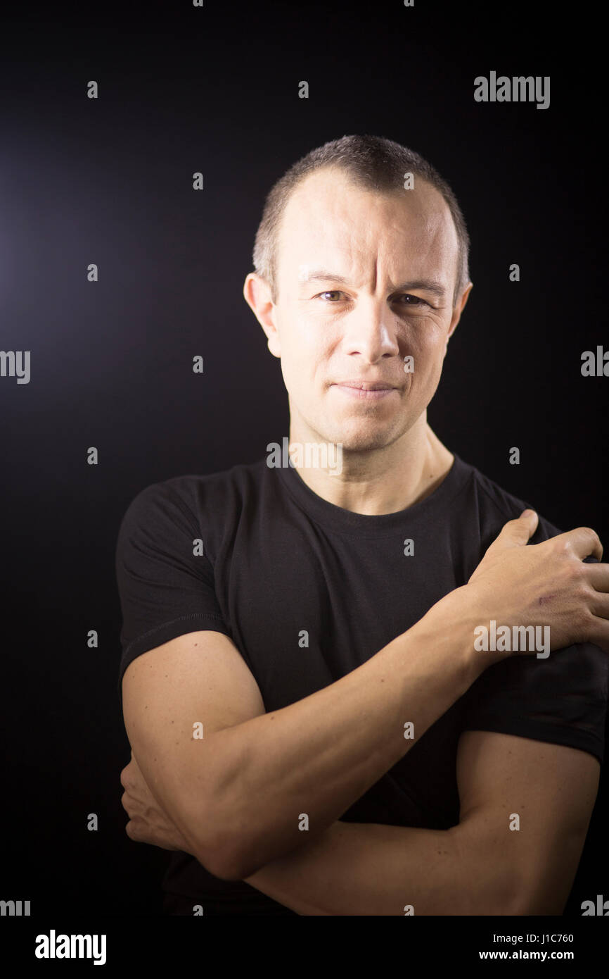 Attractive handsome slim healthy man aged in 40’s in black t-shirt