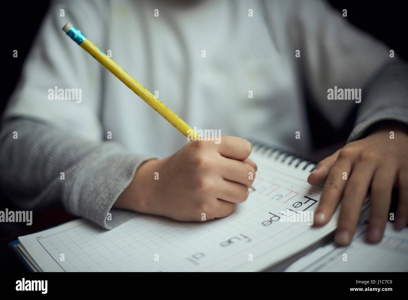 Hispanic boy practicing writing alphabet Stock Photo