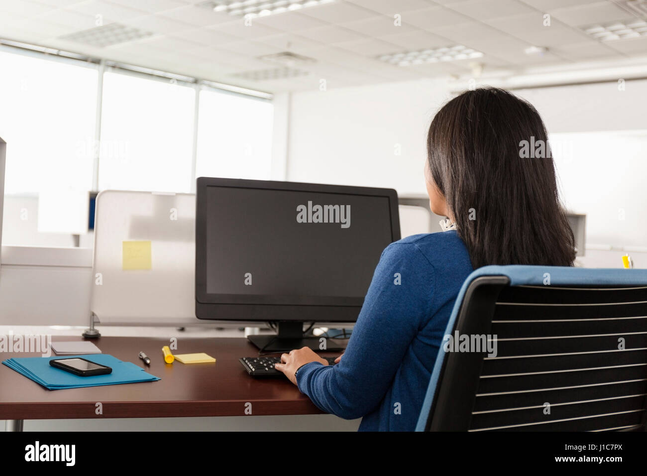 Pacific Islander woman using computer in office Stock Photo