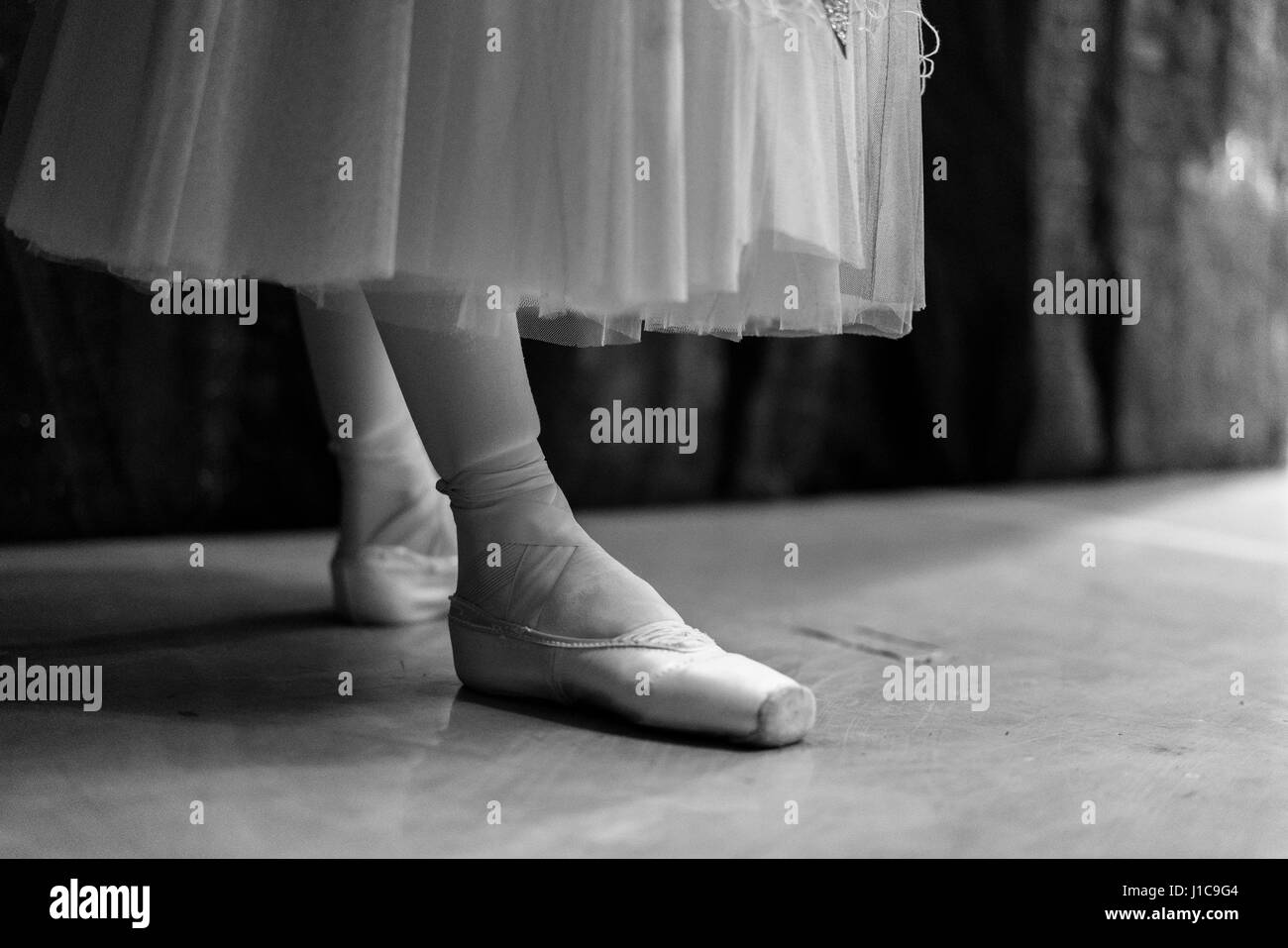 Legs of woman wearing ballet shoes Stock Photo