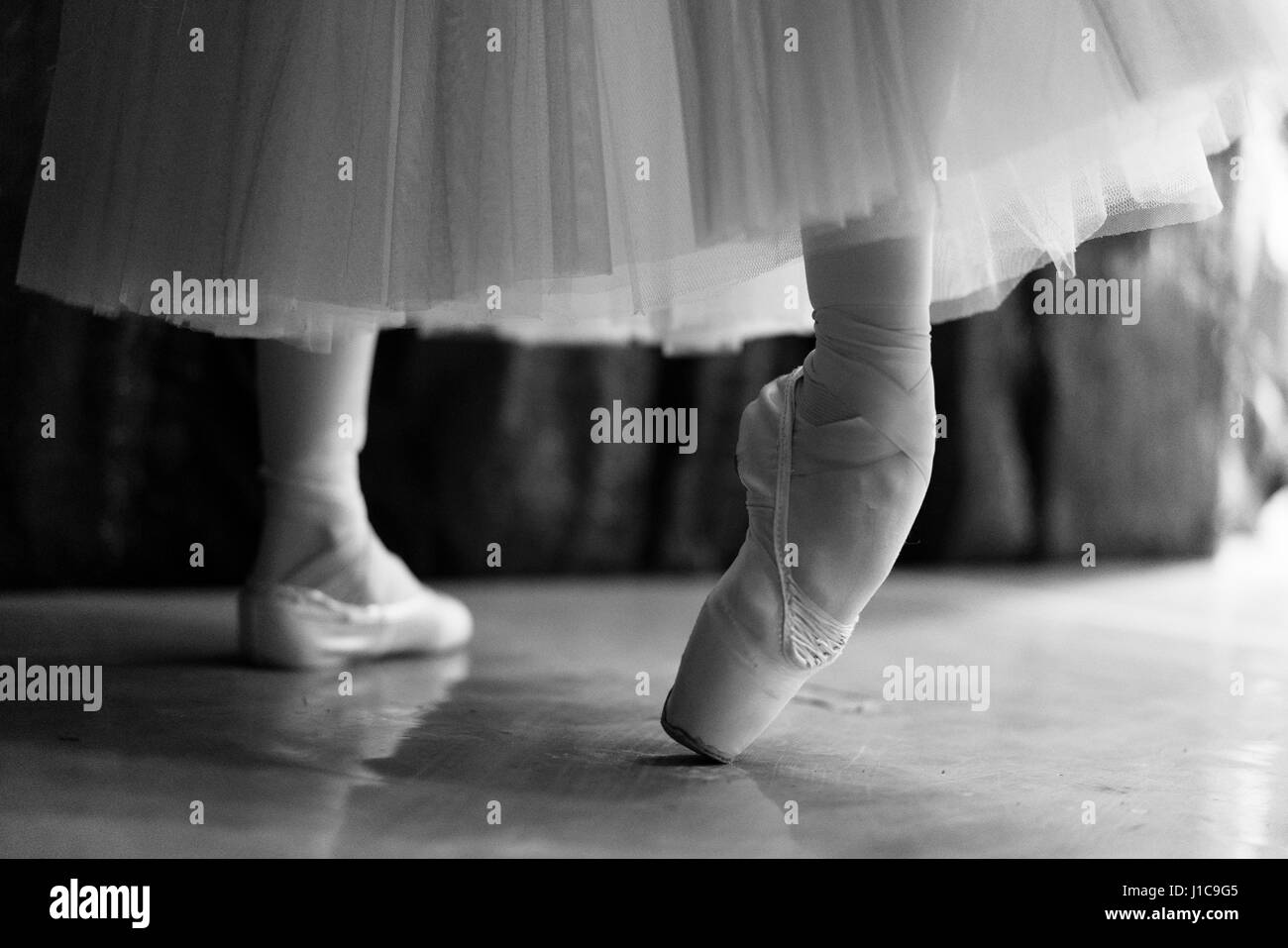 Legs of woman stretching in ballet shoes Stock Photo