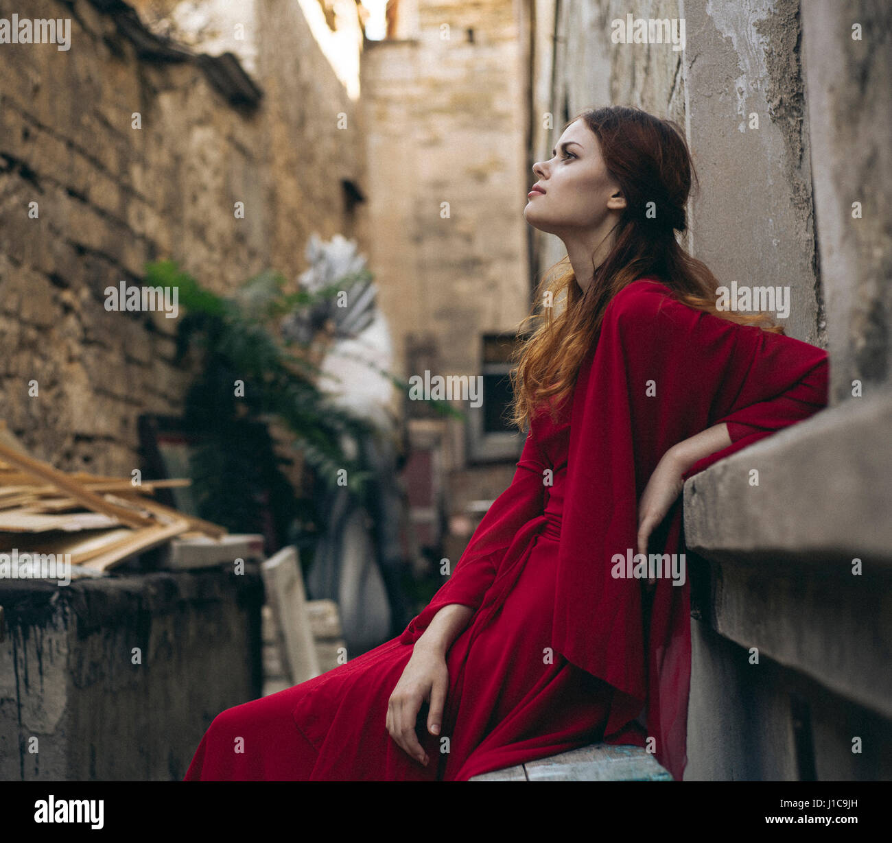 Woman red dress sitting hi-res stock photography and images - Alamy