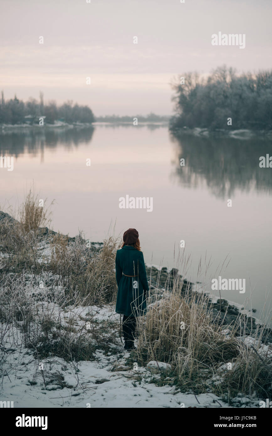 Caucasian woman standing near river in winter Stock Photo - Alamy