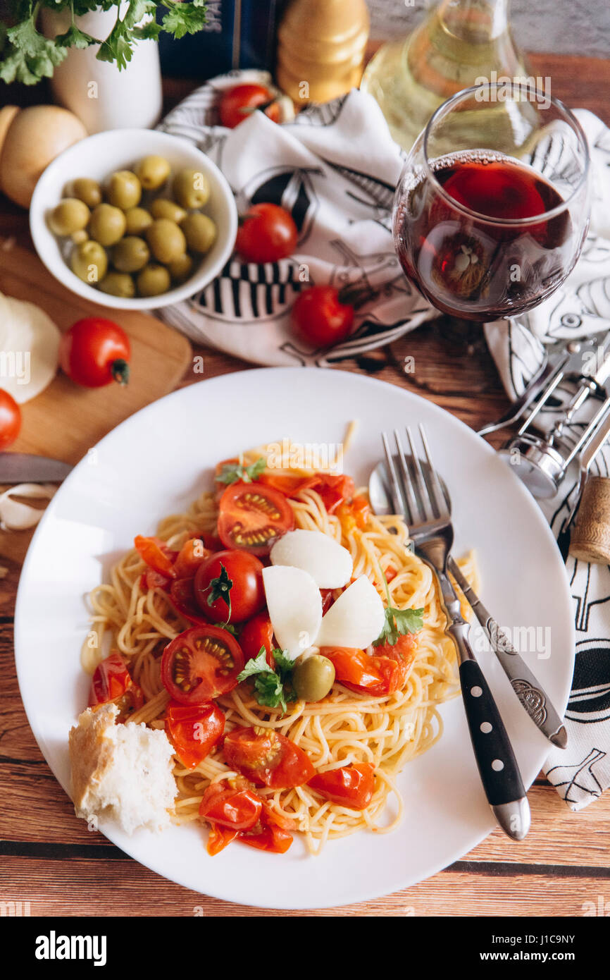 Spaghetti with bread, tomatoes and wine Stock Photo