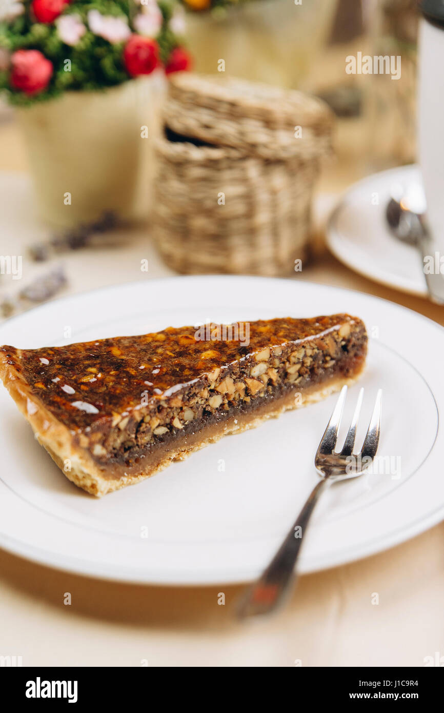 Slice of caramel tart on plate with fork Stock Photo