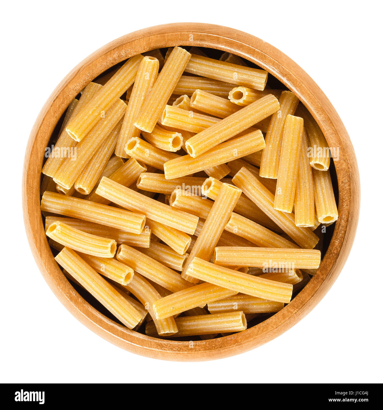 Chickpeas sedanini rigati pasta in wooden bowl. Uncooked dried glutenfree noodles made from Cicer arietinum flour. Short length tubes with ridges. Stock Photo