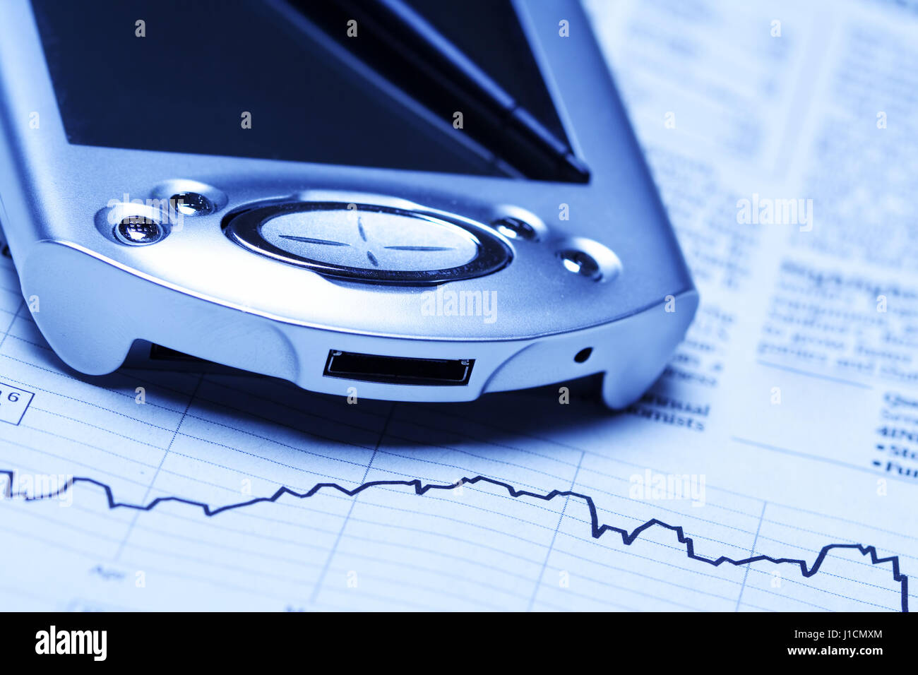 A shot of a PDA and financial chart Stock Photo Alamy