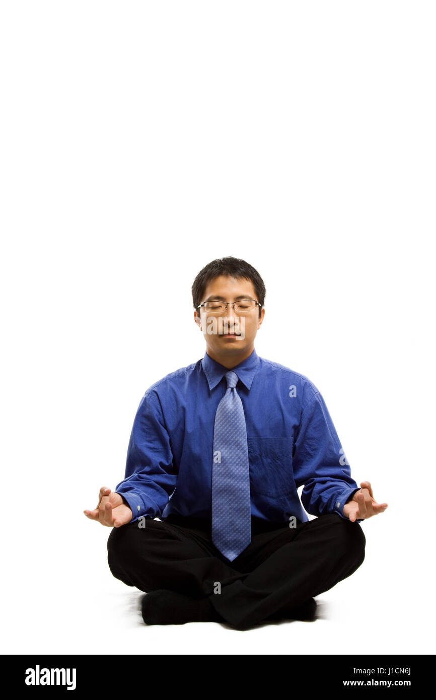 An isolated shot of a businessman meditating Stock Photo - Alamy