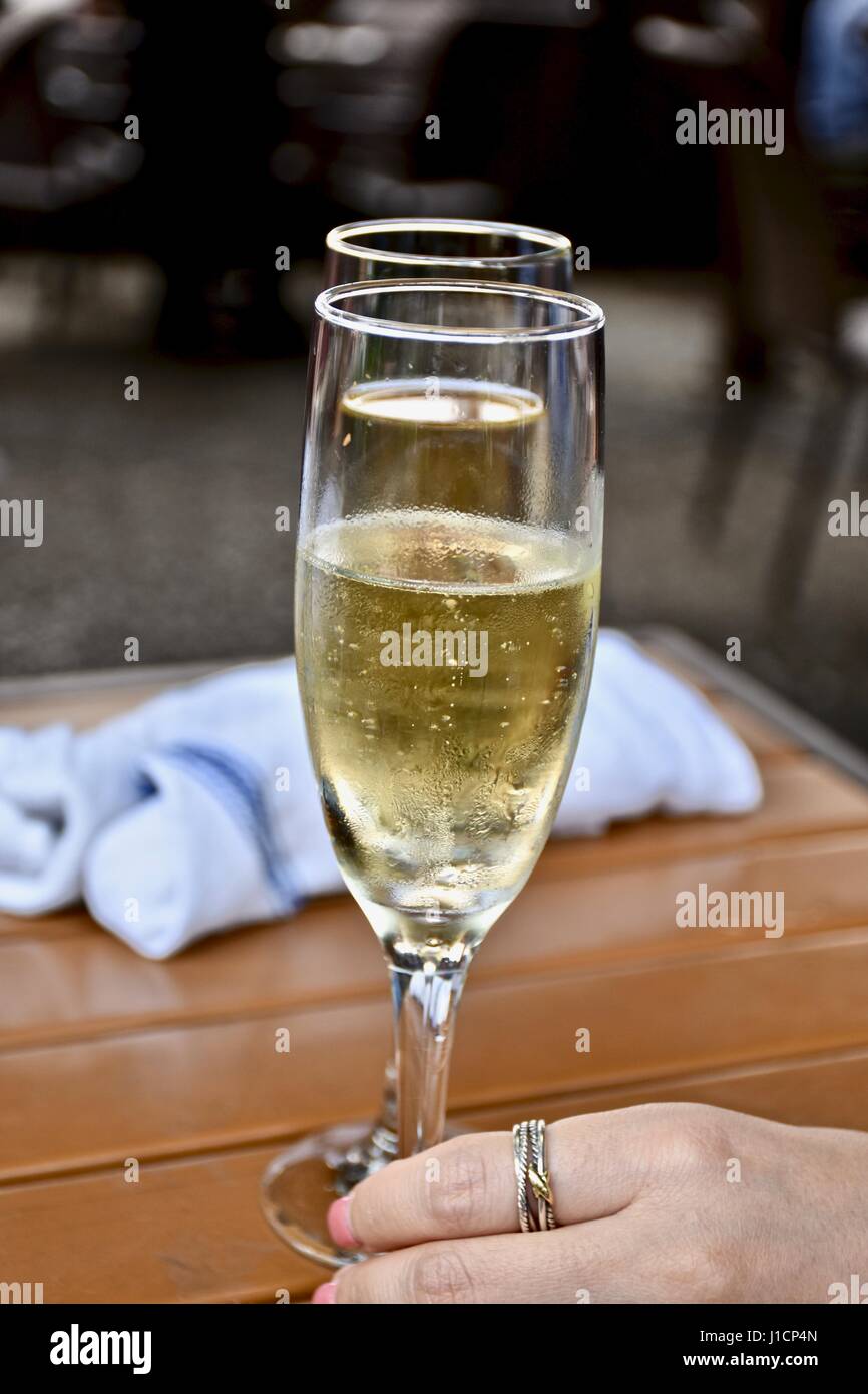 glass of champagne in woman's hand Stock Photo