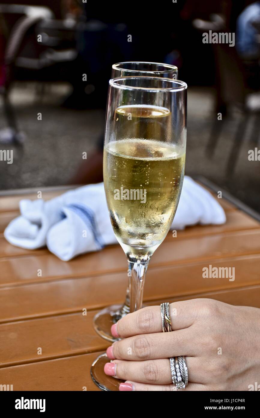 glass of champagne in woman's hand Stock Photo