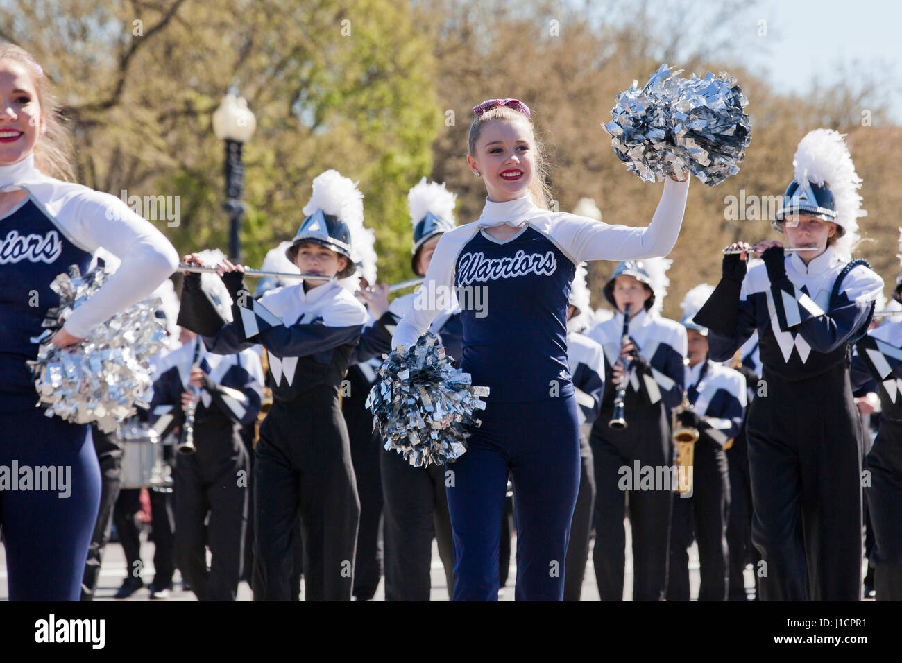 Caucasian female cheerleader participating in a street parade - USA Stock Photo