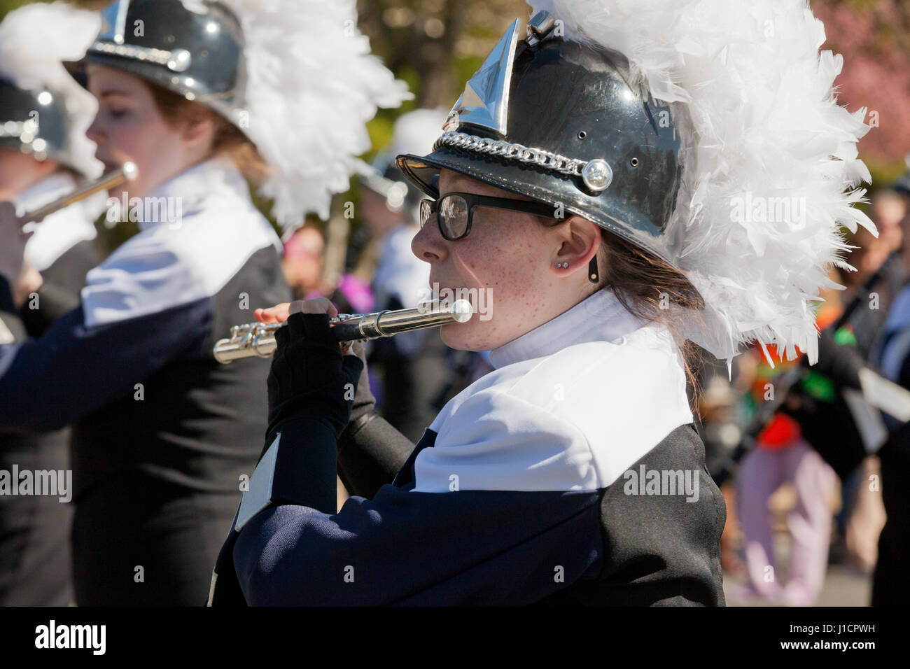 Flute player in a high school marching band during a street parade - USA Stock Photo